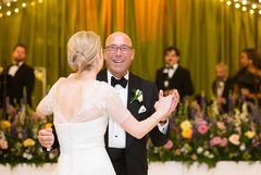 Bride dancing with her father, smiling during father/daughter dance at wedding